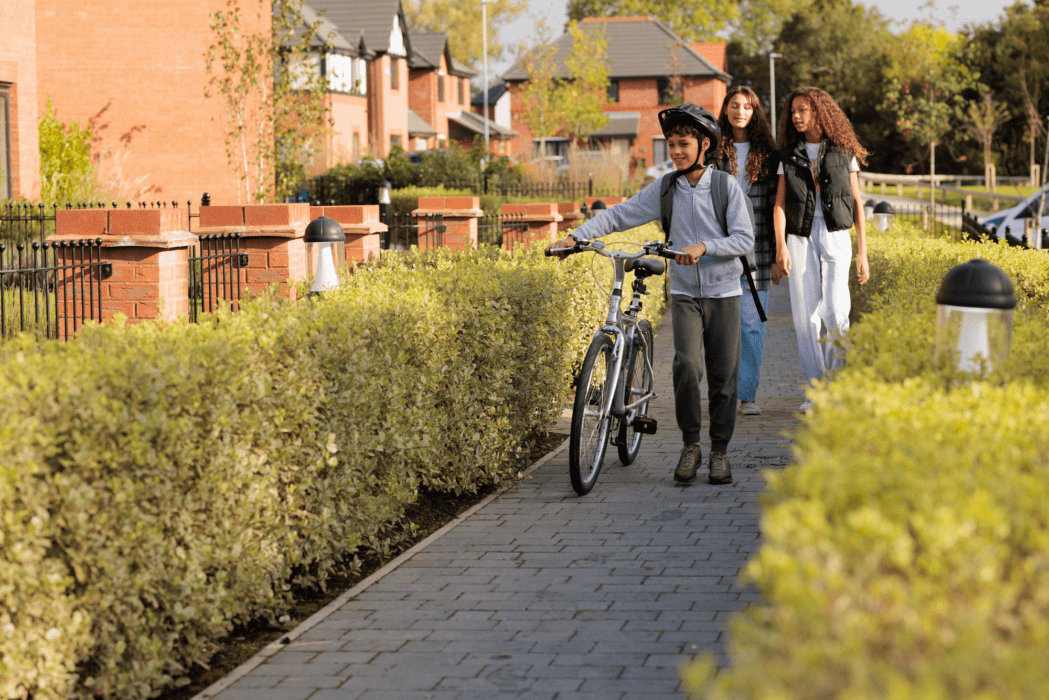 3 children walking through an Anwyl development